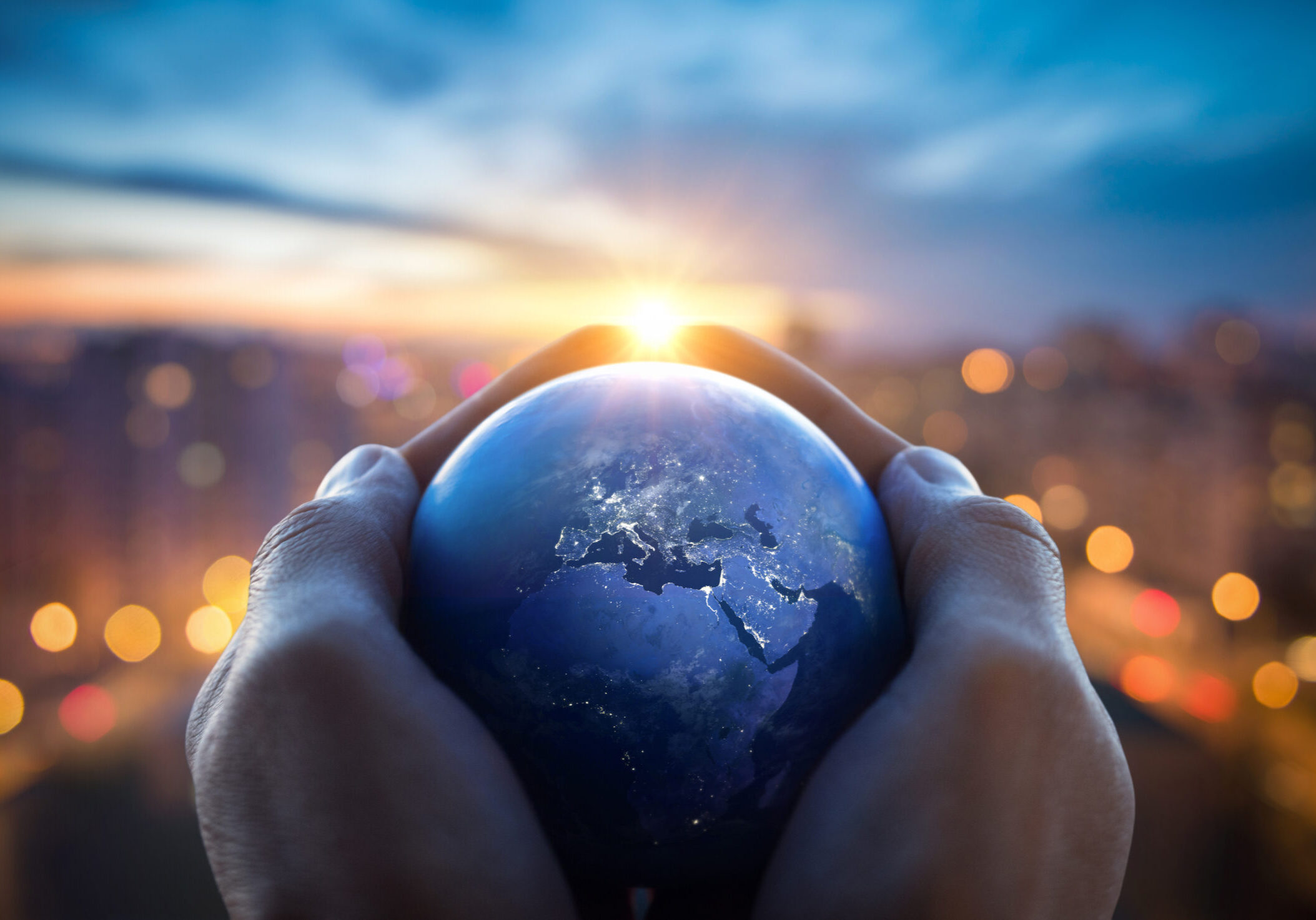 The globe Earth in the hands of man against the night city. Conc The globe Earth in the hands of man against the night city. Concept on business, politics, ecology and media. Earth day abstract background. Elements of this image furnished by NASA.
